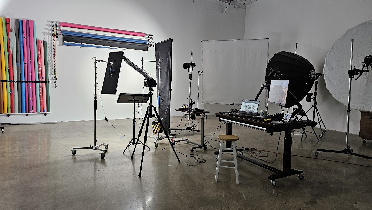 Professional headshot studio rental in Houston at West Loop Rental Studio featuring Studio B with 20 foot ceilings and the signature triangle lighting setup and seamless paper color backgrounds.
